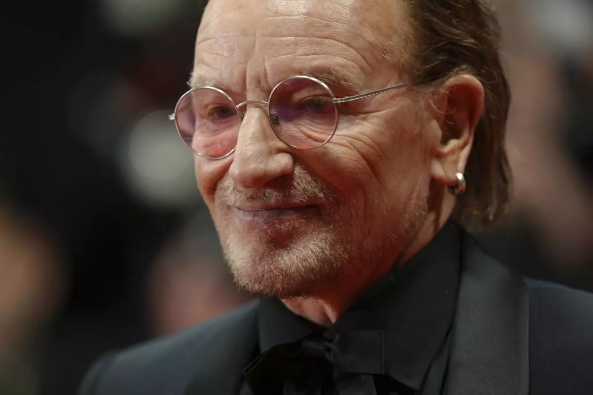 Bono poses for photographers upon arrival at the premiere of the film 'Bono: Stories of Surrender' at the 78th international film festival, Cannes, southern France, Friday, May 16, 2025. (Photo by Lewis Joly/Invision/AP)