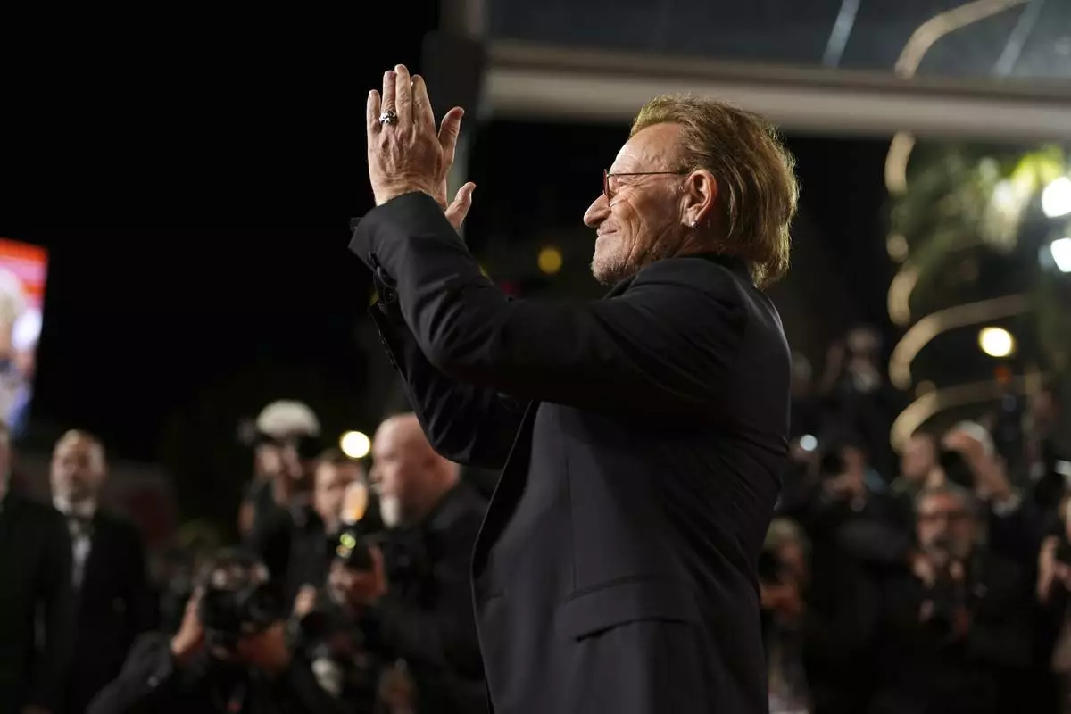 Bono poses for photographers upon arrival at the premiere of the film 'Bono: Stories of Surrender' at the 78th international film festival, Cannes, southern France, Friday, May 16, 2025. (AP Photo/Natacha Pisarenko)