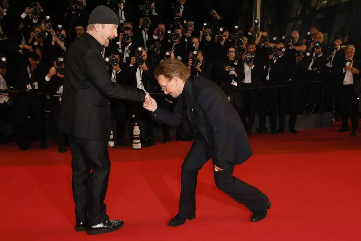 The Edge, left, and Bono pose for photographers upon arrival at the premiere of the film 'Bono: Stories of Surrender' at the 78th international film festival, Cannes, southern France, Friday, May 16, 2025. (Photo by Joel C Ryan/Invision/AP)