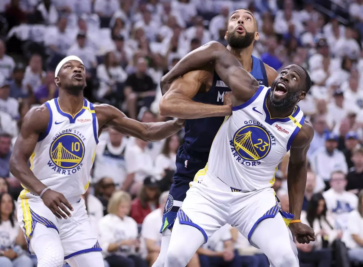 Golden State Warriors' Draymond Green and Jimmy Butler III vie for rebound position against Minnesota Timberwolves' Rudy Gobert in NBA Western Conference Semifinals' Game 5 at Target Center in Minneapolis on Wednesday, May 14, 2025. (Scott Strazzante/San Francisco Chronicle via AP)
