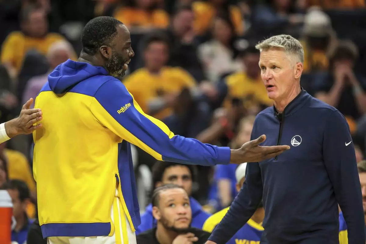 Golden State Warriors' Draymond Green (23) talks with head coach Steve Kerr after he fouled out during Game 3 of an NBA basketball second-round playoff series against the Minnesota Timberwolves in San Francisco, Saturday, May 10, 2025. (Carlos Avila Gonzalez/San Francisco Chronicle via AP)