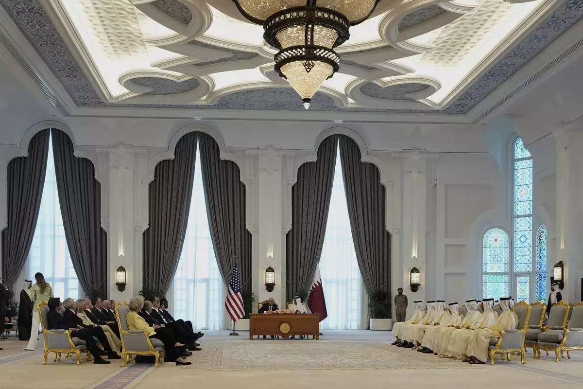 President Donald Trump and Qatar's Emir Sheikh Tamim bin Hamad Al Thani sign documents during a signing ceremony at the Amiri Diwan in Doha, Qatar, Wednesday, May 14, 2025. (AP Photo/Alex Brandon)