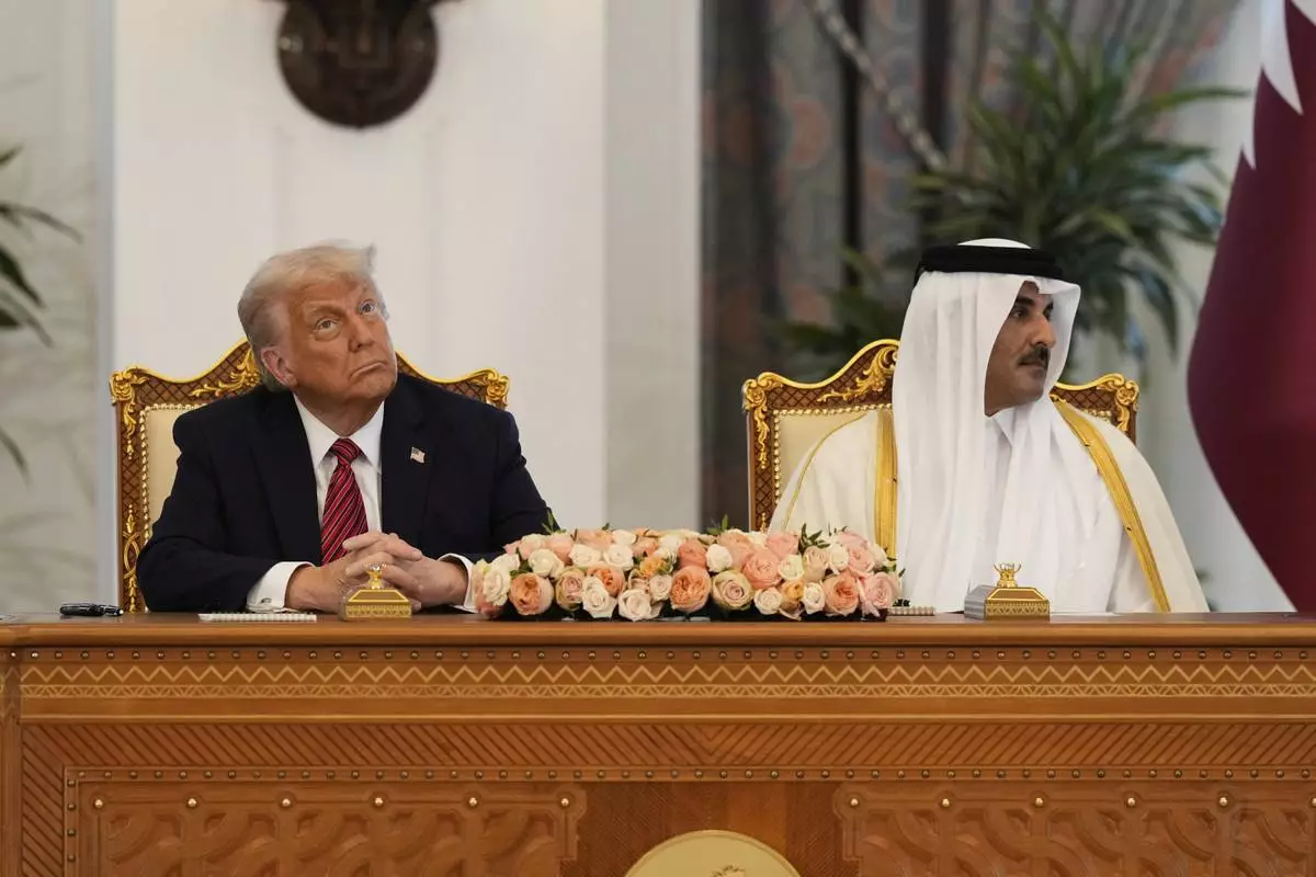 President Donald Trump and Qatar's Emir Sheikh Tamim bin Hamad Al Thani attend a signing ceremony at the Amiri Diwan in Doha, Qatar, Wednesday, May 14, 2025. (AP Photo/Alex Brandon)