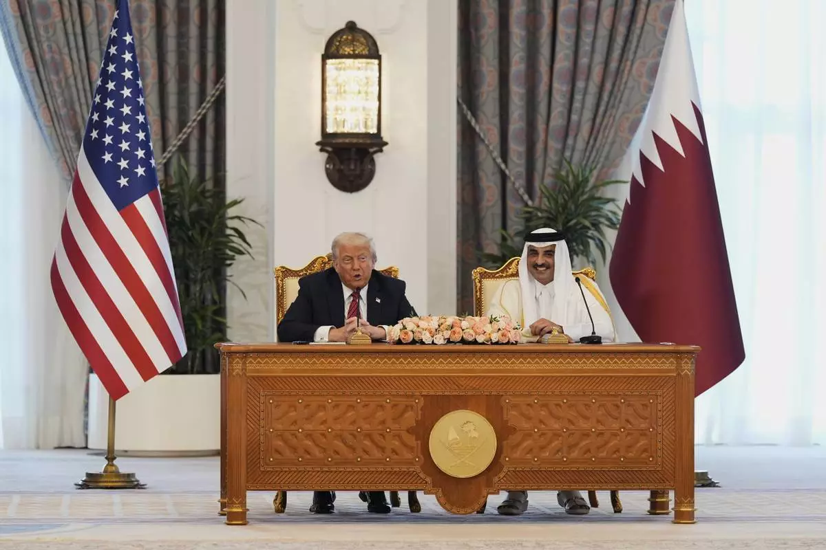 President Donald Trump speaks a signing ceremony with Qatar's Emir Sheikh Tamim bin Hamad Al Thani at the Amiri Diwan in Doha, Qatar, Wednesday, May 14, 2025. (AP Photo/Alex Brandon)