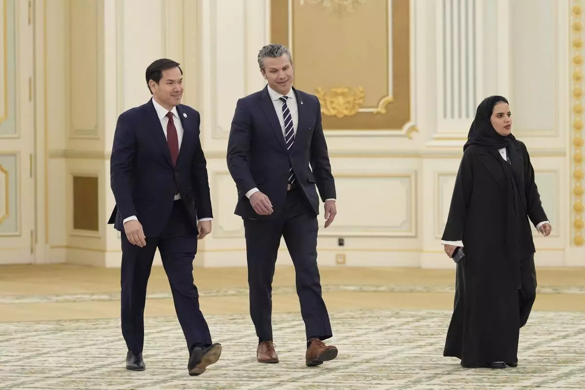 Secretary of Defense Pete Hegseth, right, and Secretary of State Marco Rubio arrive for a signing ceremony at the Royal Palace in Riyadh, Saudi Arabia, Tuesday, May 13, 2025. (AP Photo/Alex Brandon)