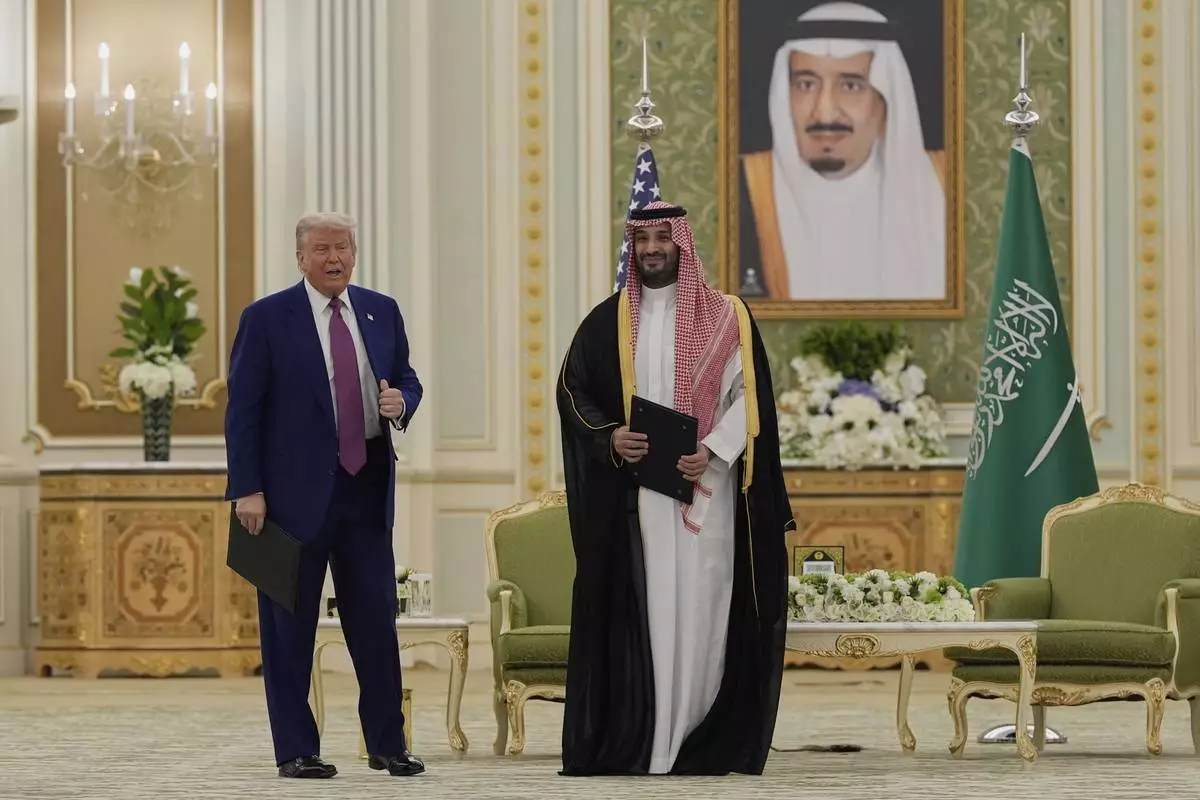 President Donald Trump and Saudi Crown Prince Mohammed bin Salman pose for a photo after exchanging documents during a signing ceremony at the Royal Palace in Riyadh, Saudi Arabia, Tuesday, May 13, 2025. (AP Photo/Alex Brandon)