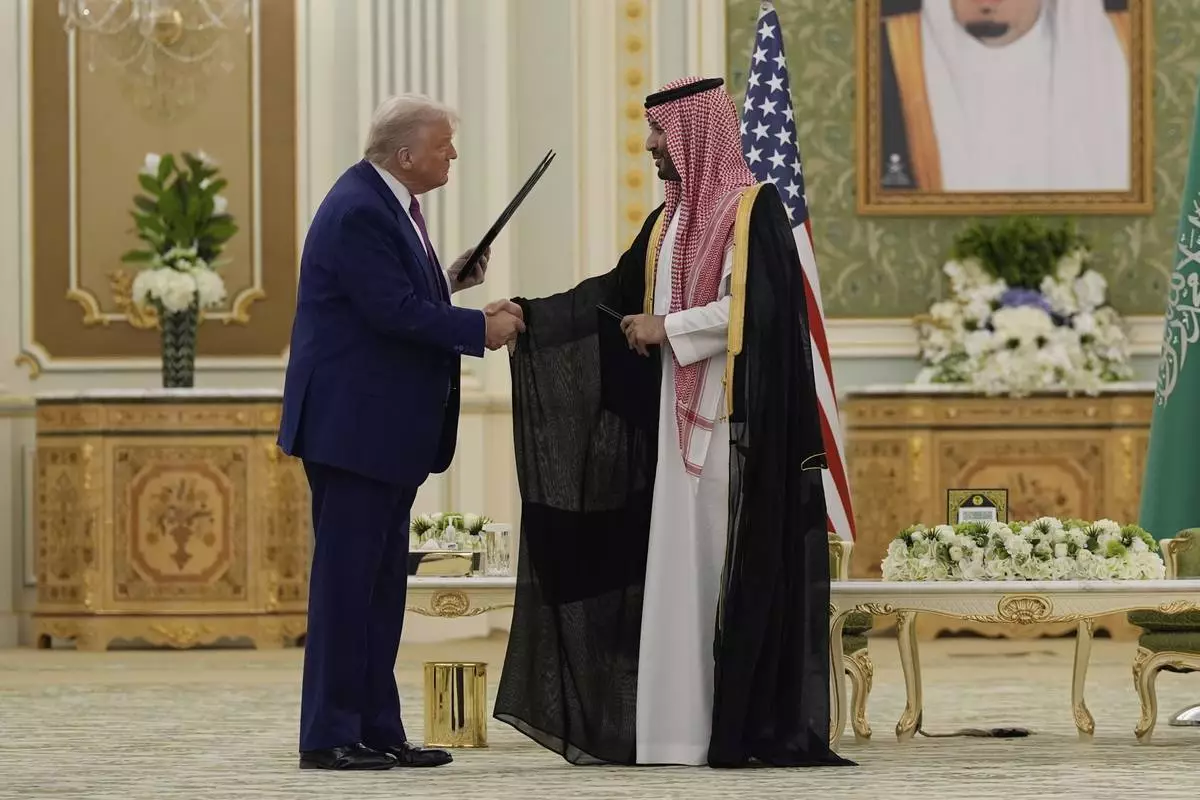 President Donald Trump and Saudi Crown Prince Mohammed bin Salman shake hands after exchanging documents during a signing ceremony at the Royal Palace in Riyadh, Saudi Arabia, Tuesday, May 13, 2025. (AP Photo/Alex Brandon)