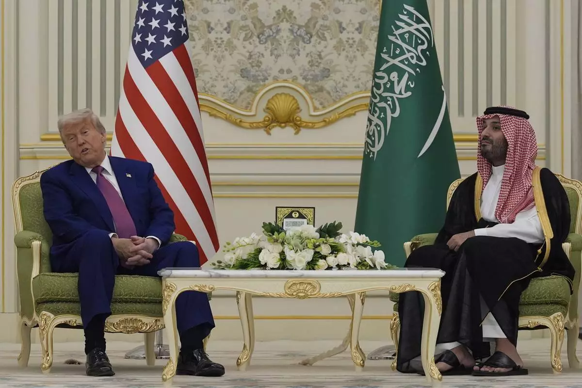 President Donald Trump and Saudi Crown Prince Mohammed bin Salman speak as they attend a signing ceremony at the Royal Palace in Riyadh, Saudi Arabia, Tuesday, May 13, 2025. (AP Photo/Alex Brandon)