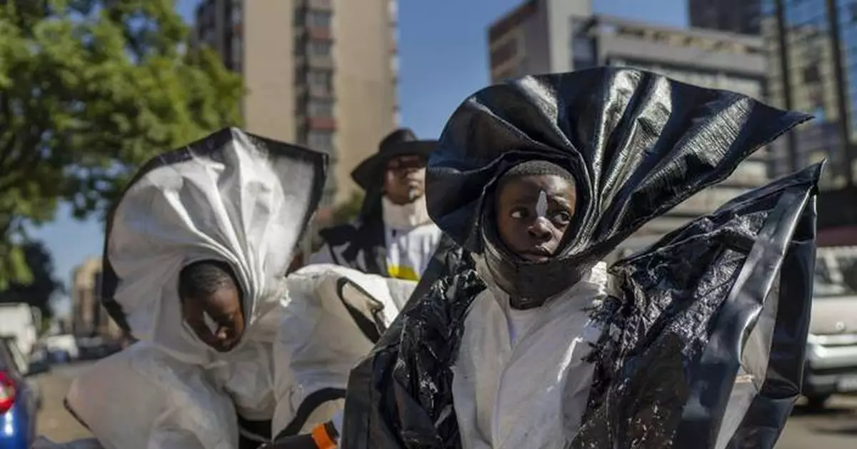 AP PHOTOS: A street parade lights up South Africa's tough Hillbrow district