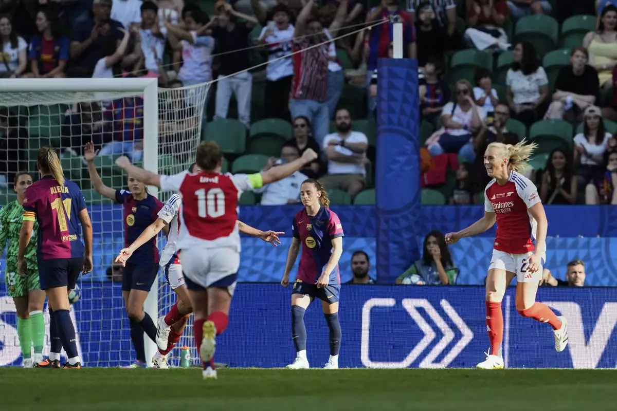 Arsenal's Stina Blackstenius, right, celebrates with teammates after scoring the opening goal during the women's Champions League final soccer match between Arsenal and FC Barcelona at the Jose Alvalade stadium in Lisbon, Saturday, May 24, 2025. (AP Photo/Armando Franca)