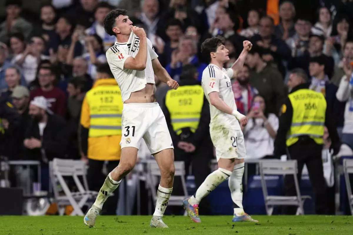 Real Madrid's Jacobo Ramon, left, celebrates with Fran Garcia after scoring his side's second goal during a Spanish La Liga soccer match between Real Madrid and Mallorca in Madrid, Spain, Wednesday, May 14, 2025. (AP Photo/Manu Fernandez)
