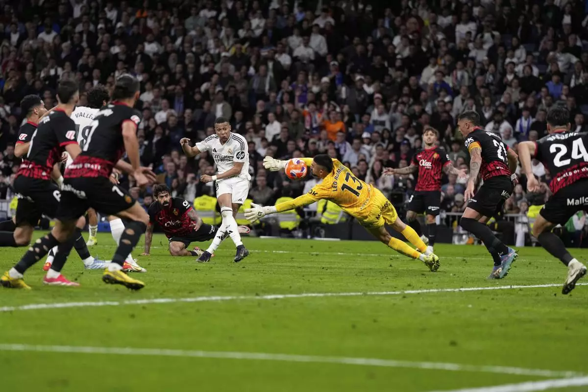 Real Madrid's Kylian Mbappe, centre left, shoots on goal during a Spanish La Liga soccer match between Real Madrid and Mallorca in Madrid, Spain, Wednesday, May 14, 2025. (AP Photo/Manu Fernandez)