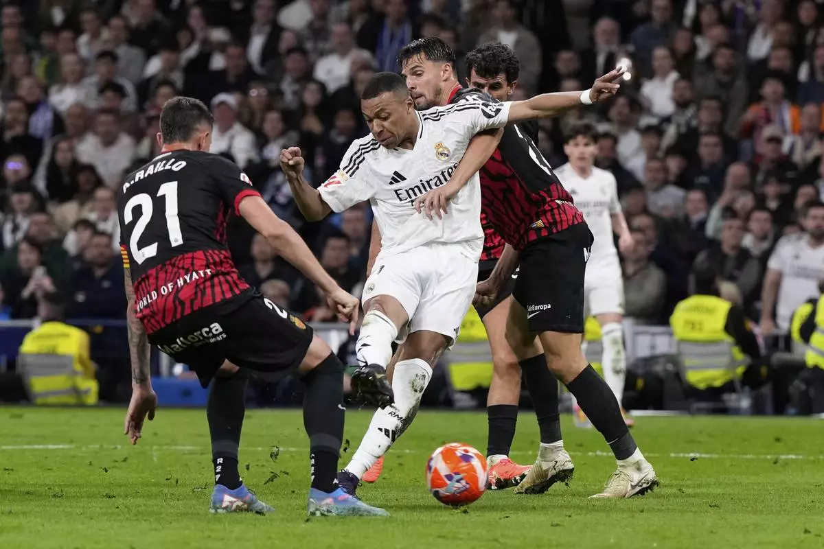 Real Madrid's Kylian Mbappe, centre, scores his side's first goal during a Spanish La Liga soccer match between Real Madrid and Mallorca in Madrid, Spain, Wednesday, May 14, 2025. (AP Photo/Manu Fernandez)