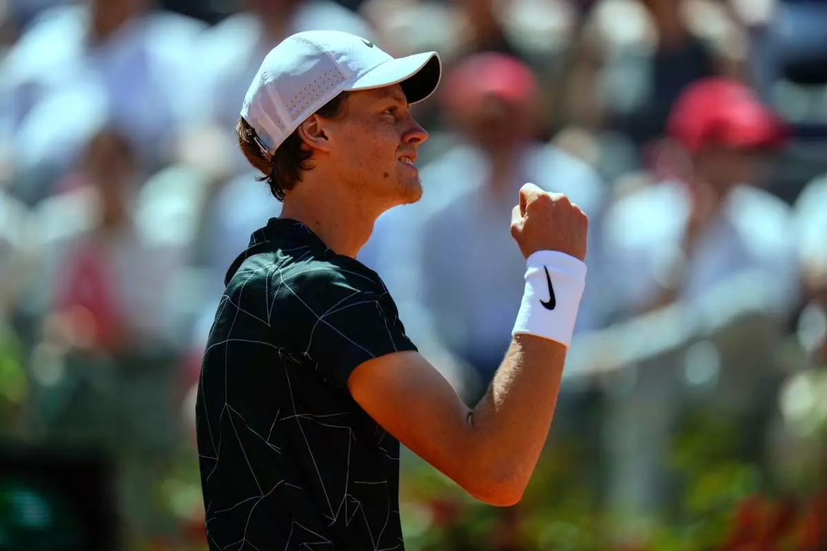 FILE - Italy's Jannik Sinner celebrates after winning a point to Greece's Stefanos Tsitsipas during their match at the Italian Open tennis tournament, in Rome, May 13, 2022. (AP Photo/Alessandra Tarantino, File)