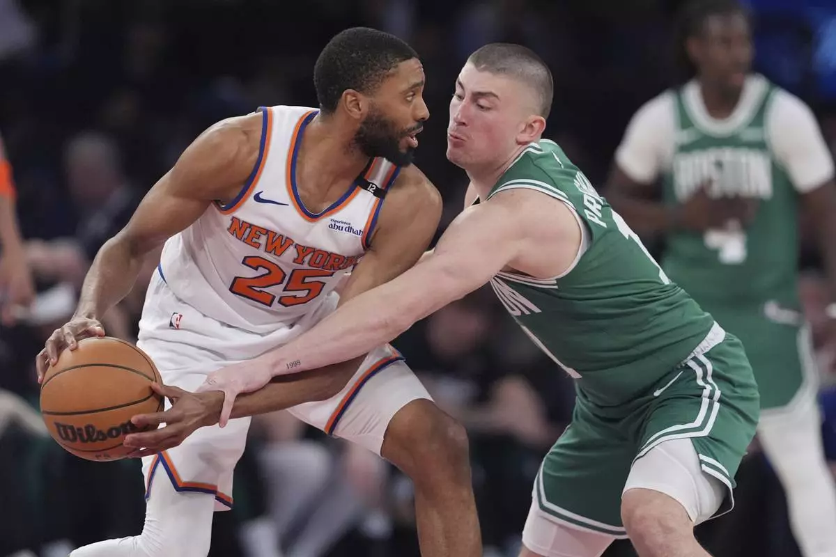 Boston Celtics' Payton Pritchard, right, defends New York Knicks' Mikal Bridges during the second half of Game 6 in the Eastern Conference semifinals of the NBA basketball playoffs Friday, May 16, 2025, in New York. (AP Photo/Frank Franklin II)