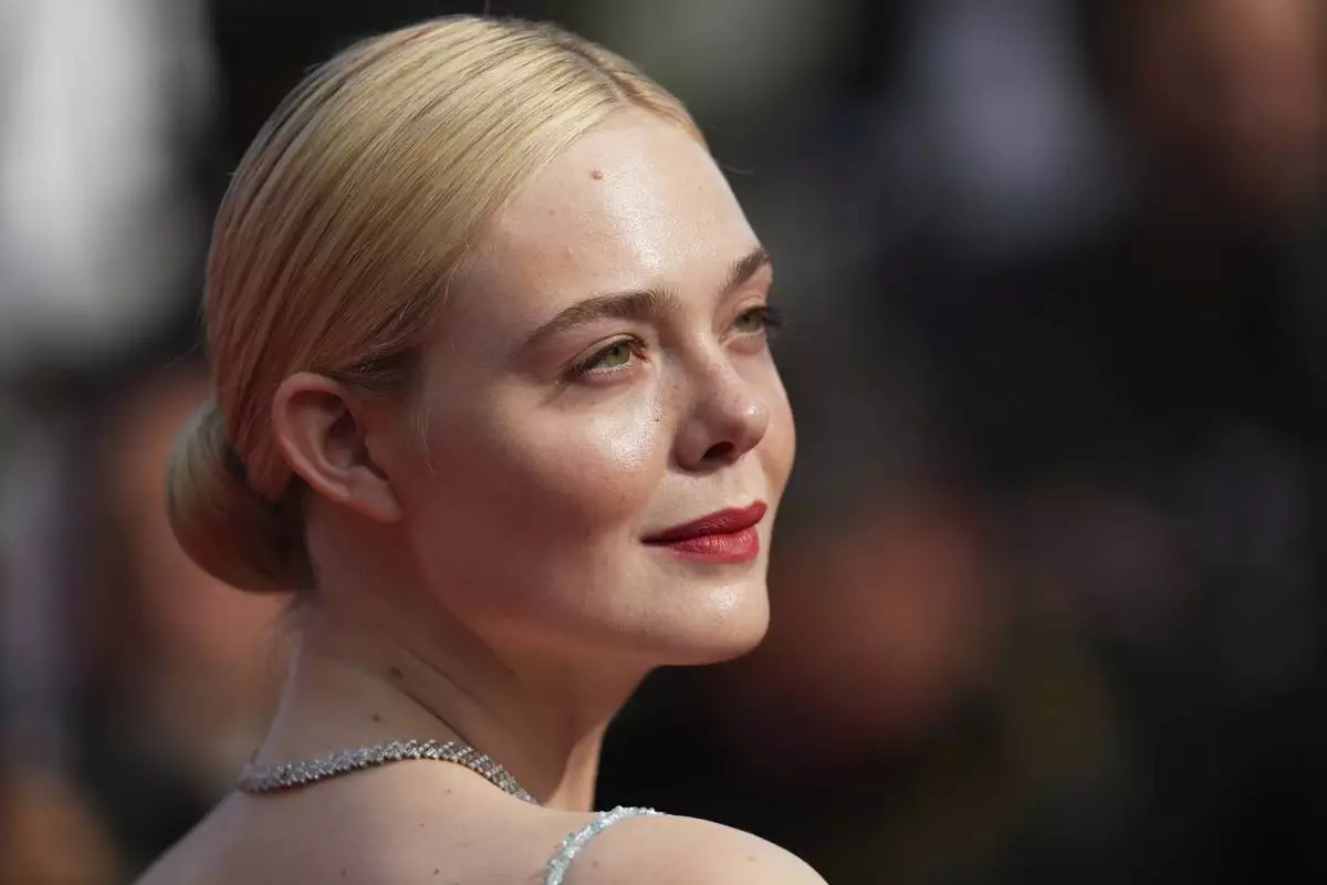 Elle Fanning poses for photographers during the awards ceremony red carpet at the 78th international film festival, Cannes, southern France, Saturday, May 24, 2025. (AP Photo/Natacha Pisarenko)