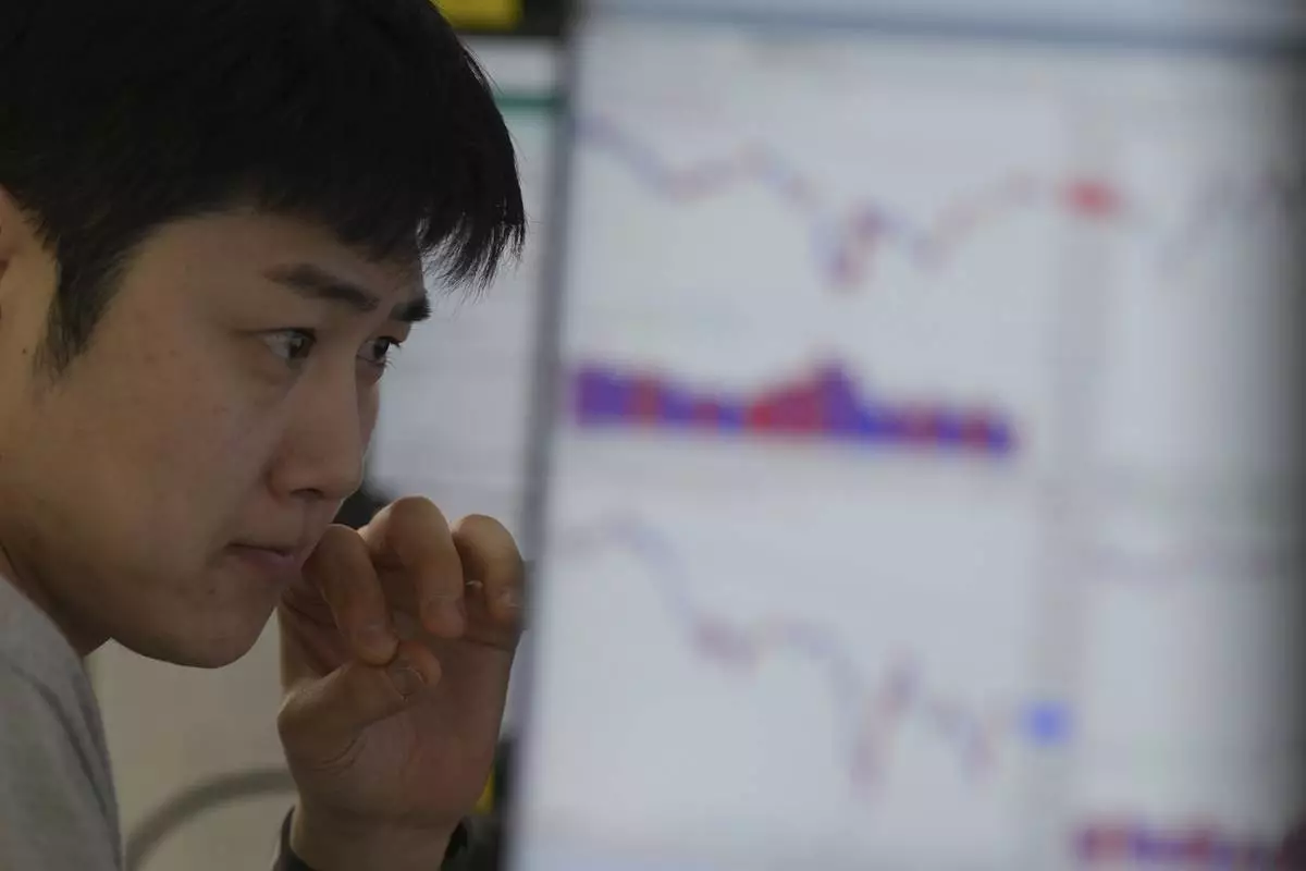 A dealer watches computer monitors at a dealing room of Hana Bank in Seoul, South Korea, Wednesday, May 7, 2025. (AP Photo/Lee Jin-man)