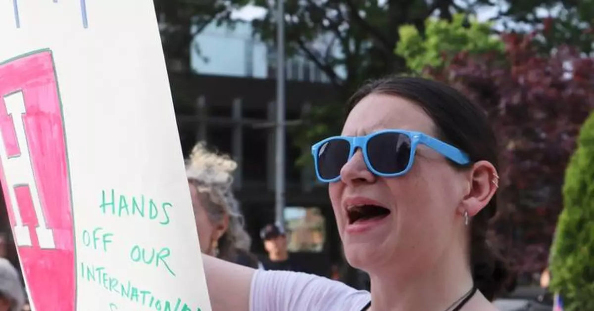 Harvard grads cheer commencement speakers who urge the school to stand strong