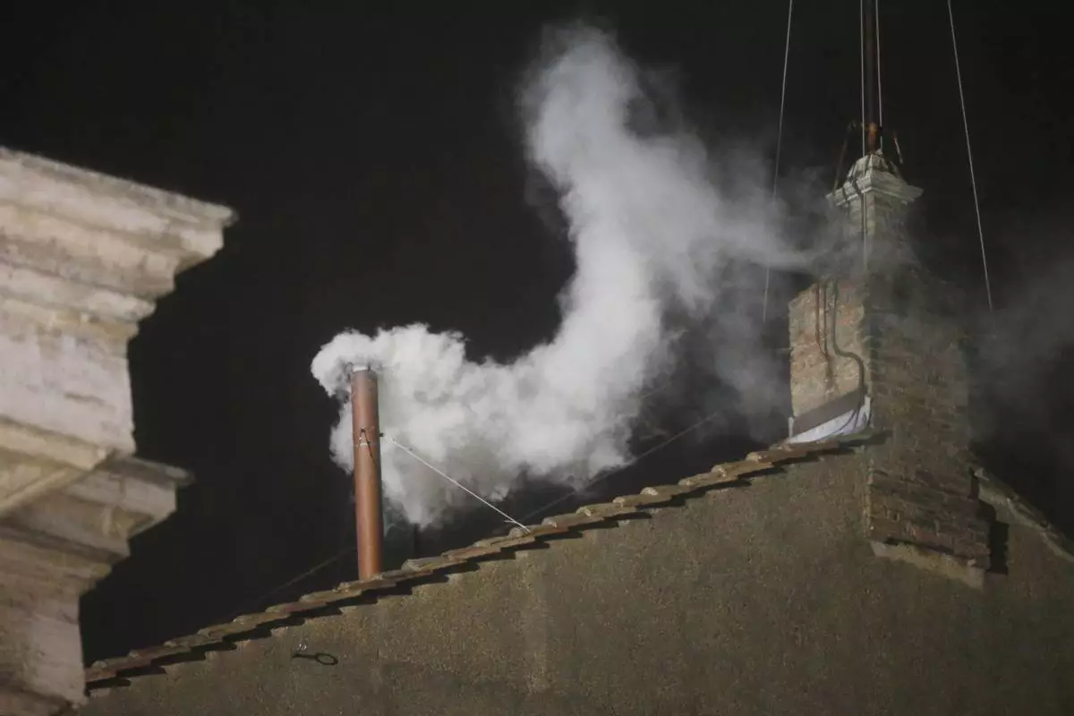 FILE - White smoke is seen billowing out from the chimney of the Sistine Chapel and announcing that a new pope has been elected on Wednesday, March 13, 2013. (AP Photo/Gregorio Borgia, File)