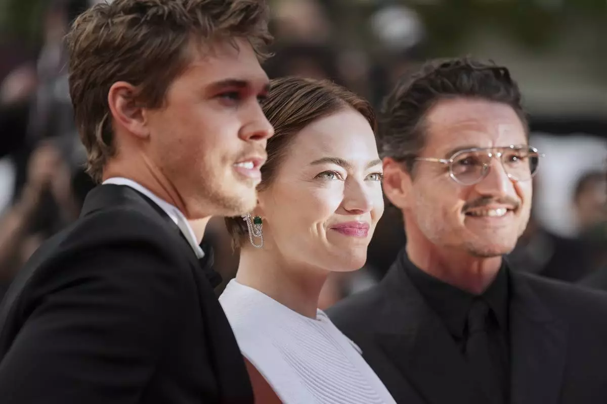 Austin Butler, from left, Emma Stone and Austin Butler pose for photographers upon arrival at the premiere of the film 'Eddington' at the 78th international film festival, Cannes, southern France, Friday, May 16, 2025. (AP Photo/Natacha Pisarenko)