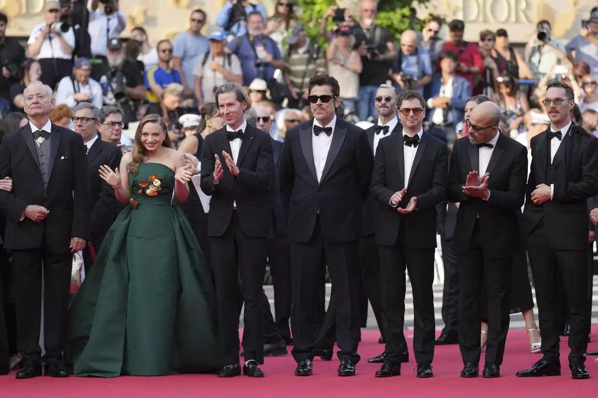 Bill Murray, from left, Mia Threapleton, director Wes Anderson, Benicio del Toro, Michael Cera, Jeffrey Wright and Benedict Cumberbatch pose for photographers upon arrival at the premiere of the film 'The Phoenician Scheme' at the 78th international film festival, Cannes, southern France, Sunday, May 18, 2025. (AP Photo/Natacha Pisarenko)