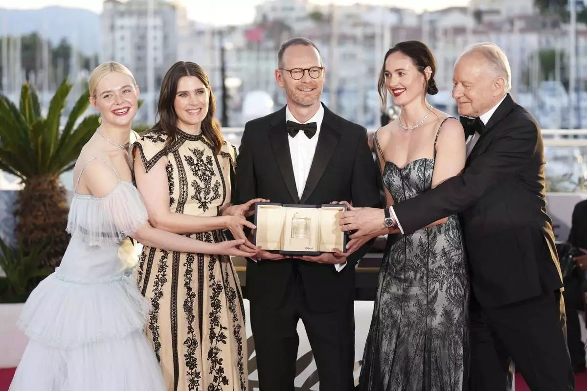 Director Joachim Trier, centre, winner of the grand prix for the film 'Sentimental Value', poses with Elle Fanning, from left, Inga Ibsdotter Lilleaas, Renate Reinsve and Stellan Skarsgard at the awards ceremony photo call at the 78th international film festival, Cannes, southern France, Saturday, May 24, 2025. (Photo by Scott A Garfitt/Invision/AP)