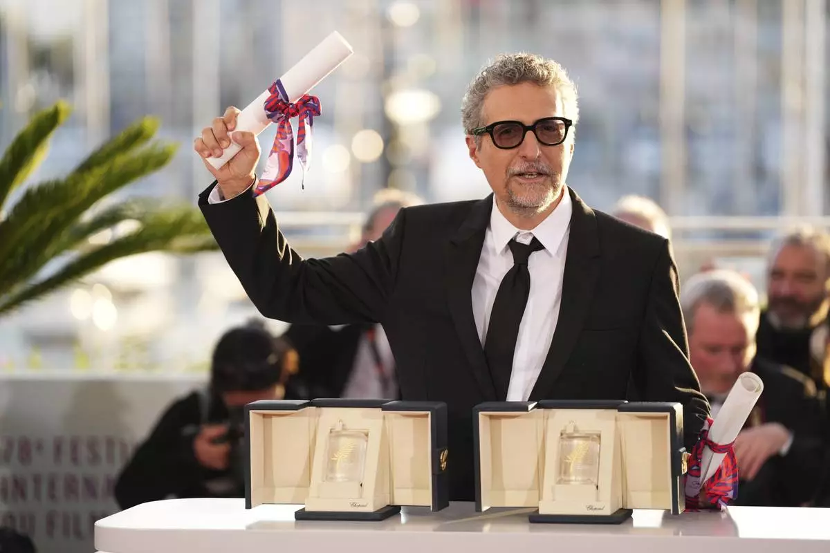 Director Kleber Mendonca Filho poses with his award for best director for the film 'The Secret Agent' as well as the best actor award received on behalf of Wagner Moura at the awards ceremony photo call at the 78th international film festival, Cannes, southern France, Saturday, May 24, 2025. (Photo by Scott A Garfitt/Invision/AP)