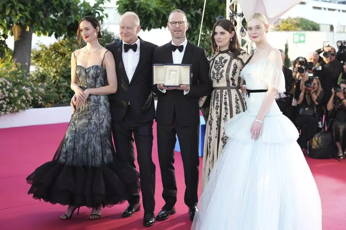 Director Joachim Trier, centre, winner of the grand prix for the film 'Sentimental Value', poses with Renate Reinsve, from left, Stellan Skarsgard, Inga Ibsdotter Lilleaas and Elle Fanning at the awards ceremony photo call at the 78th international film festival, Cannes, southern France, Saturday, May 24, 2025. (AP Photo/Natacha Pisarenko)