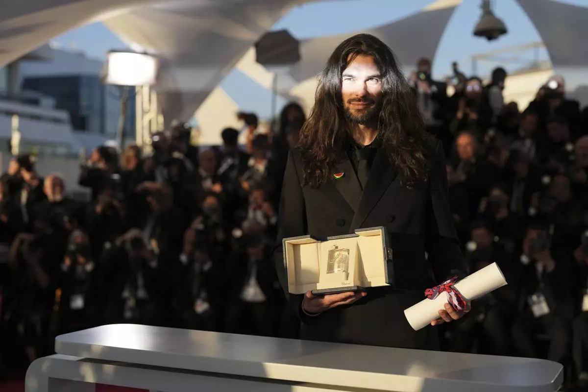 Director Oliver Laxe, winner of the jury prize for 'Sirat', poses for photographers at the awards ceremony photo call at the 78th international film festival, Cannes, southern France, Saturday, May 24, 2025. (AP Photo/Natacha Pisarenko)