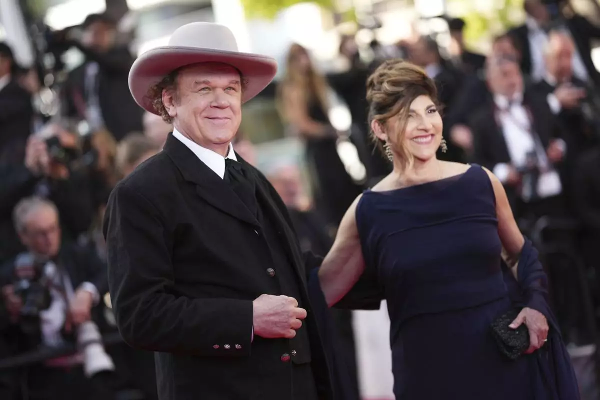 John C. Reilly, left, and Alison Dickey pose for photographers during the awards ceremony red carpet at the 78th international film festival, Cannes, southern France, Saturday, May 24, 2025. (Photo by Scott A Garfitt/Invision/AP)