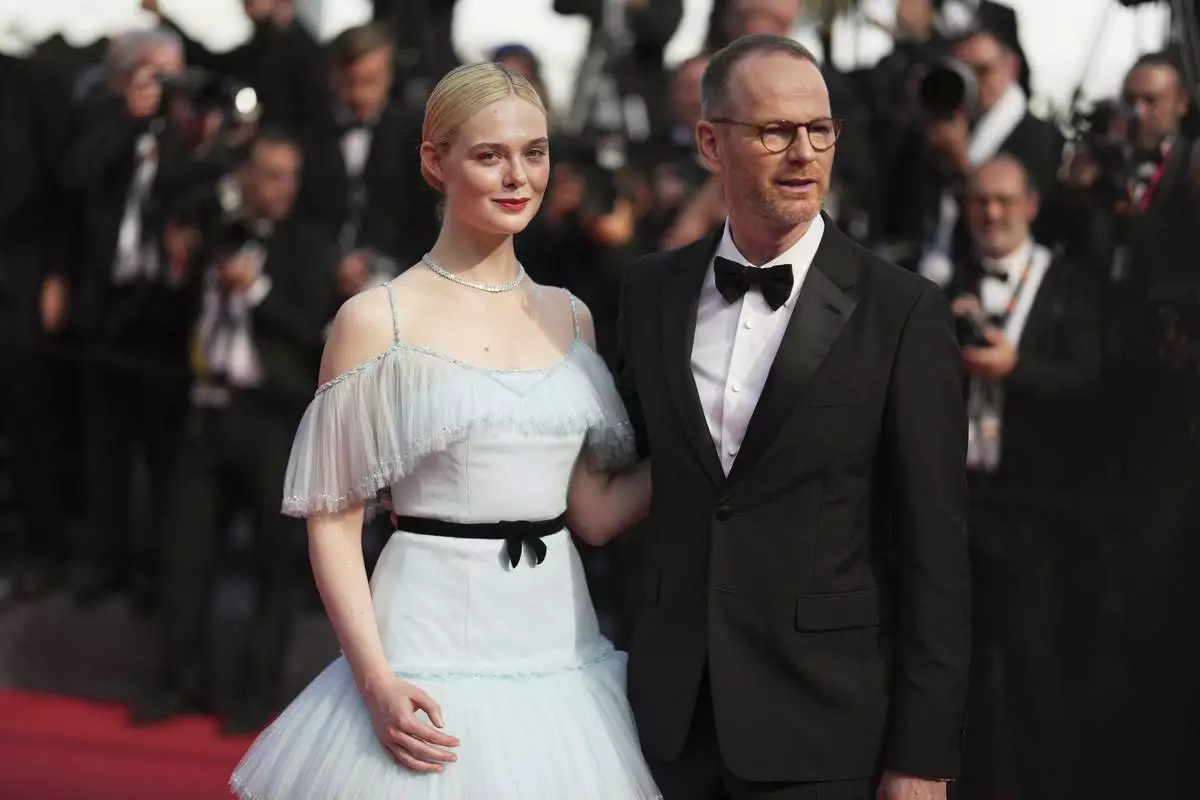 Elle Fanning, left, and Joachim Trier pose for photographers during the awards ceremony red carpet at the 78th international film festival, Cannes, southern France, Saturday, May 24, 2025. (AP Photo/Natacha Pisarenko)