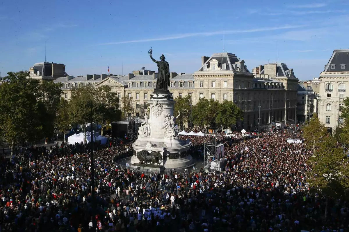 FILE - Supporters of French far-left leader Jean-Luc Melenchon are gathered on Republique square to listen their leader during a protest over the president's labor reform, in Paris, France, Saturday, Sept. 23, 2017. (AP Photo/Francois Mori, File)