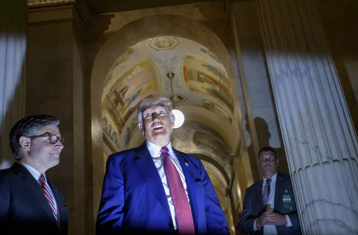 President Donald Trump, right, is joined by Speaker of the House Mike Johnson, R-La., left, as he speaks with reporters upon his departure from the Capitol following a meeting with the House Republican Conference, Tuesday, May 20, 2025, in Washington. (AP Photo/Rod Lamkey, Jr.)