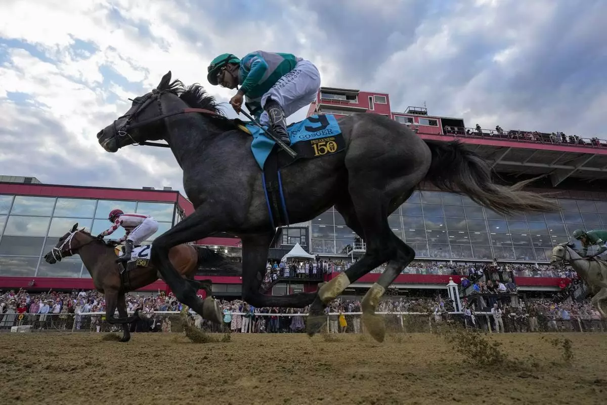 Umberto Rispoli, left, atop Journalism, edges out Luis Saez, atop Gosger, to win the 150th running of the Preakness Stakes horse race Saturday, May 17, 2025, at Pimlico Race Course in Baltimore. (AP Photo/Stephanie Scarbrough)
