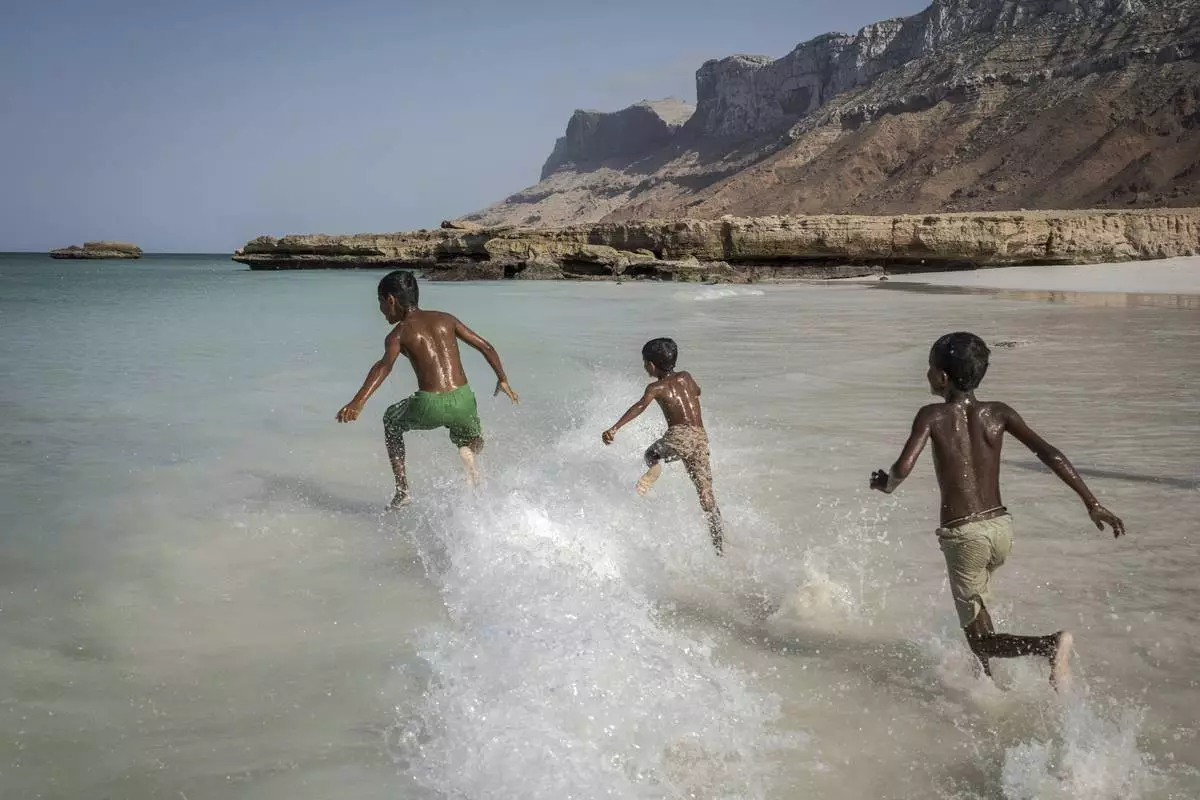 Children play in the waves on the Yemeni island of Socotra, on Sept. 22, 2024. (AP Photo/Annika Hammerschlag)
