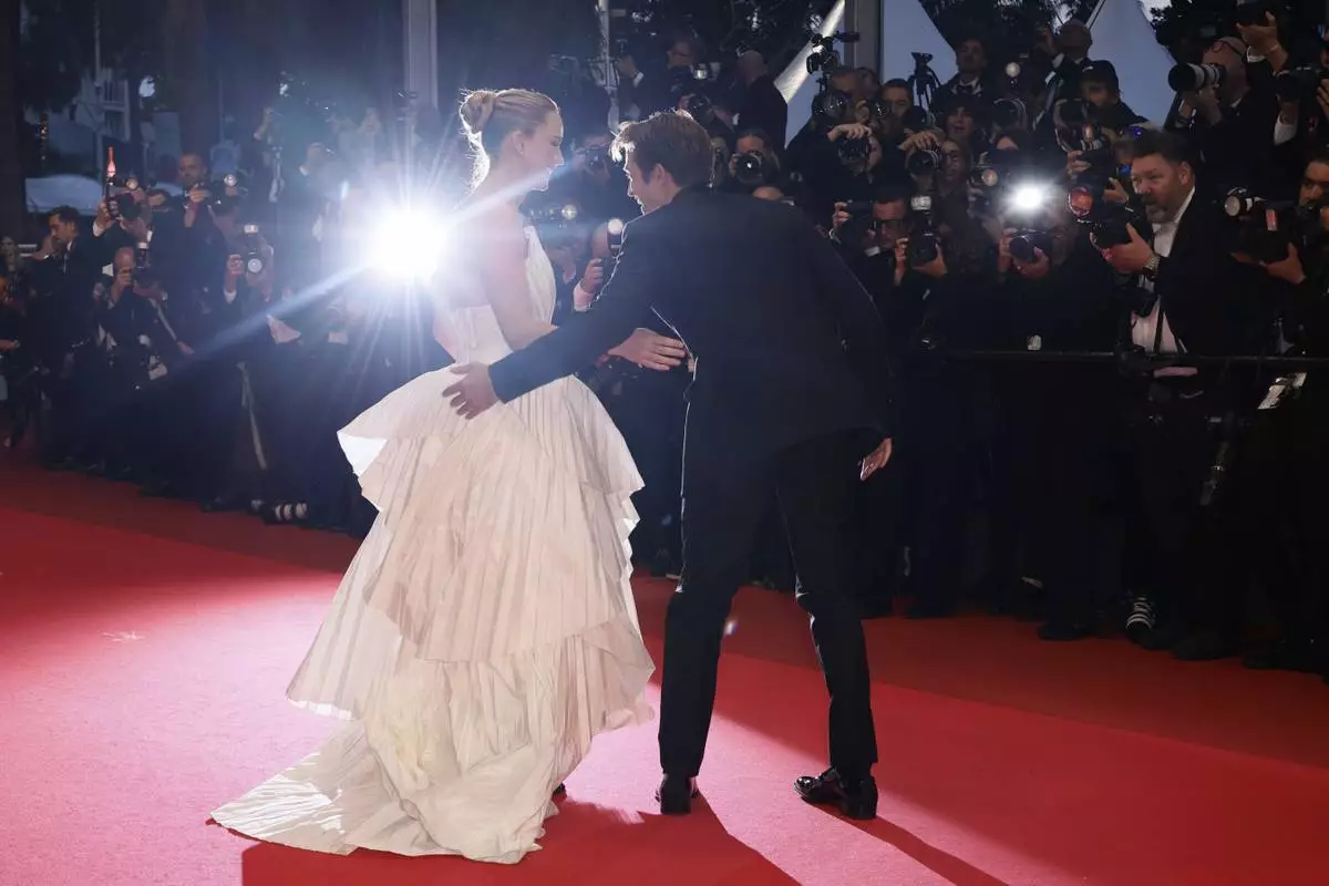 Jennifer Lawrence, left, and Robert Pattinson pose for photographers upon arrival at the premiere of the film 'Die, My Love' at the 78th international film festival, Cannes, southern France, Saturday, May 17, 2025. (Photo by Joel C Ryan/Invision/AP)