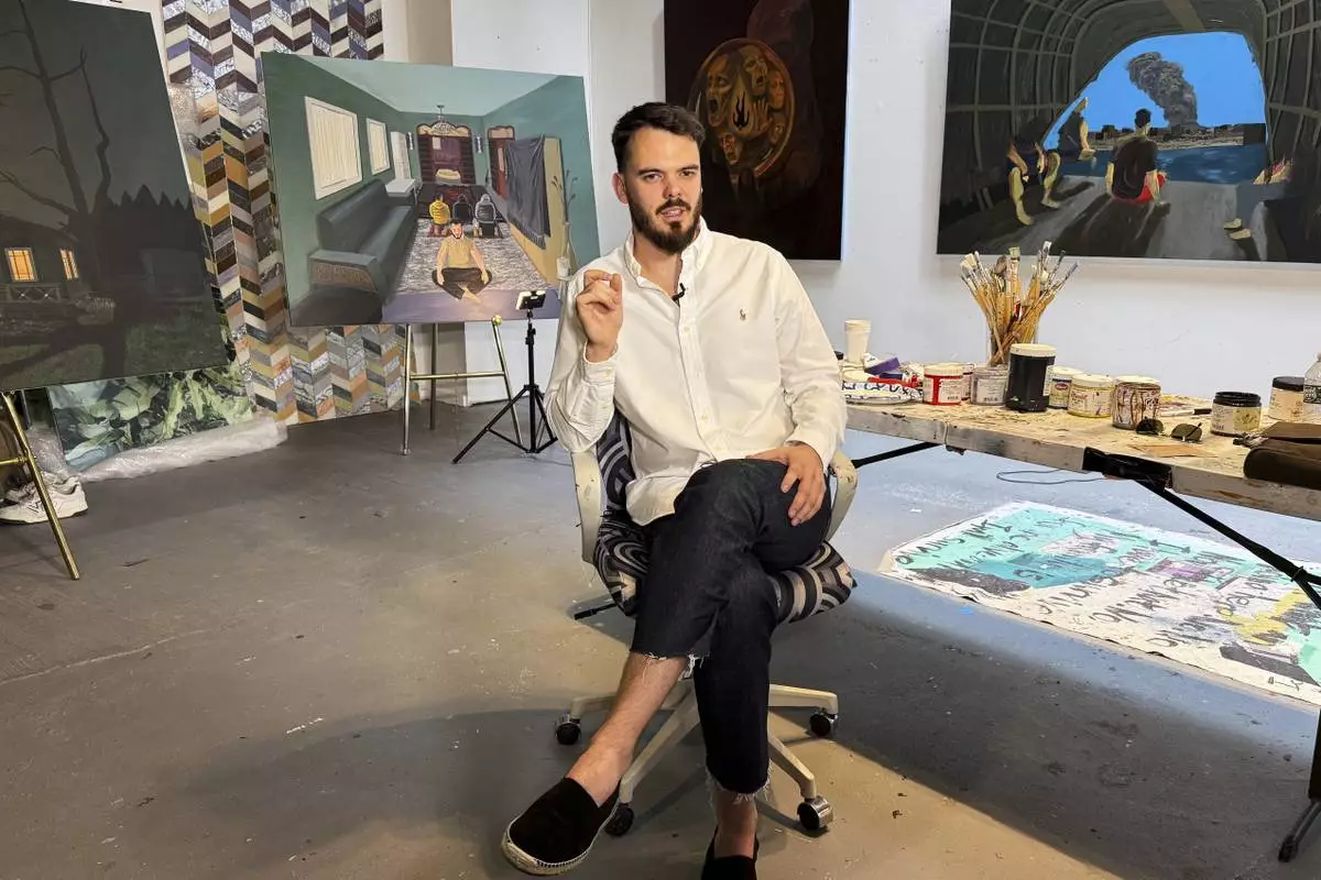 Andrei Kozlov, an artist who was taken hostage by Hamas during the Oct. 7, 2023, attack on Israel, speaks with The Associated Press during an interview Monday, May 19, 2025, at his studio in New York.