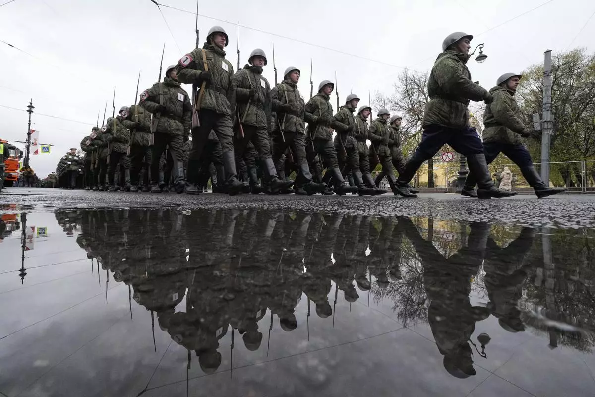 Russian army soldiers march to attend a dress rehearsal for the Victory Day military parade at the Dvortsovaya (Palace) Square in St. Petersburg, Russia, Wednesday, May 7, 2025. (AP Photo/Dmitri Lovetsky)