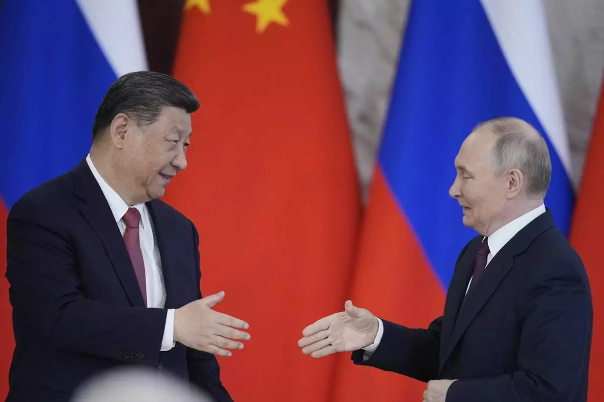 Russian President Vladimir Putin, right, and Chinese President Xi Jinpin attend a signing ceremony after their meeting at the Kremlin in Moscow, Russia, Thursday, May 8, 2025, ahead of celebrations of the 80th anniversary of the Soviet Union's victory over Nazi Germany during the World War II. (AP Photo/Pavel Bednyakov)