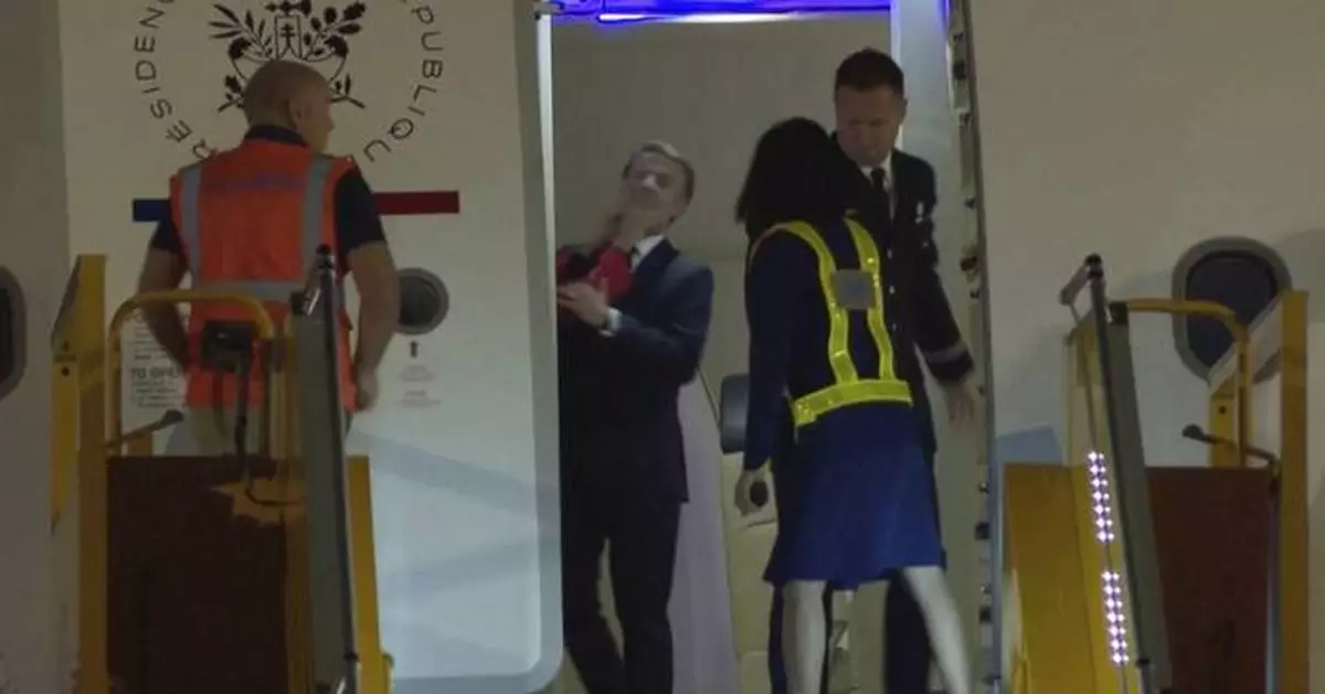 France's first lady seems to push her husband as they land in Vietnam. He says they were joking