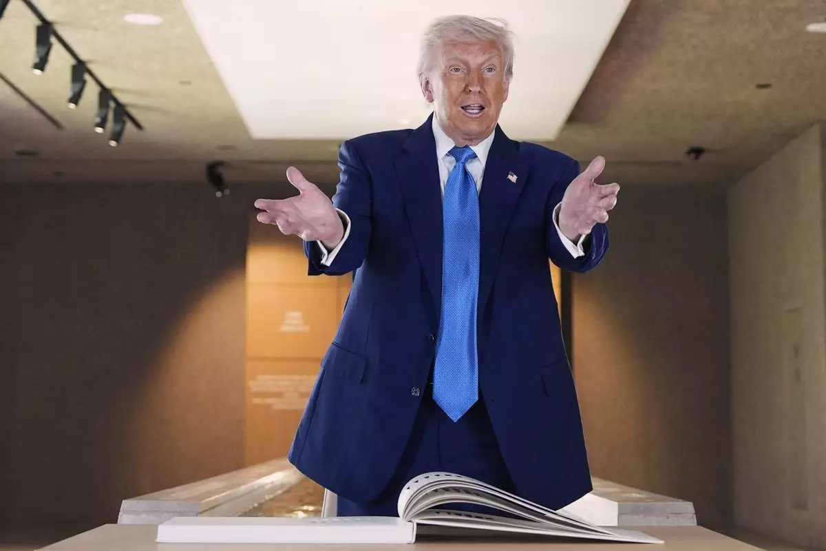 President Donald Trump talks before signing guest book at the Abrahamic Family House, Friday, May 16, 2025, in Abu Dhabi, United Arab Emirates. (AP Photo/Alex Brandon)