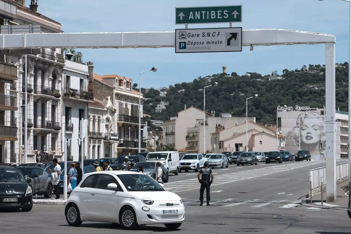 FILE - Police direct traffic during an electricity outage in Cannes, southern France, Saturday, May 24, 2025. (Photo by Lewis Joly/Invision/AP, File)