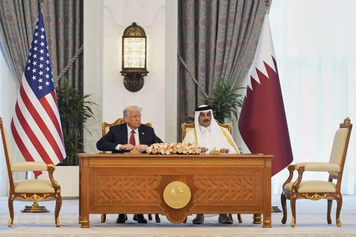 President Donald Trump and Qatar's Emir Sheikh Tamim bin Hamad Al Thani attend a signing ceremony at the Amiri Diwan in Doha, Qatar, Wednesday, May 14, 2025. (AP Photo/Alex Brandon)