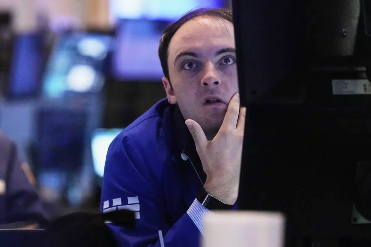 Specialist Joseph Maguire works at his post on the floor of the New York Stock Exchange, Tuesday, May 20, 2025. (AP Photo/Richard Drew)