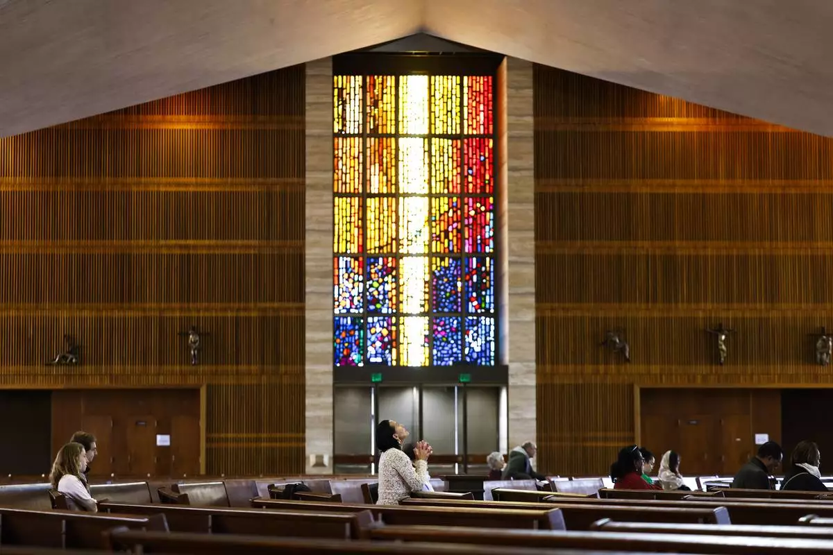 Worshippers gather for a daytime Mass at the Cathedral of Saint Mary of the Assumption in San Francisco, Thursday, May 8, 2025, after newly elected Pope Leo XIV was announced. (Jessica Christian/San Francisco Chronicle via AP)