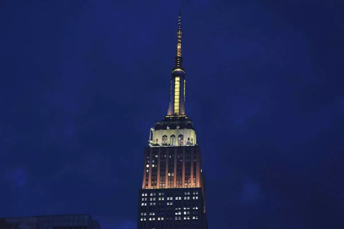 The Empire State Building is lit in gold and white in honor of Pope Leo XIV Thursday, May 8, 2025, in New York. (AP Photo/Frank Franklin II)