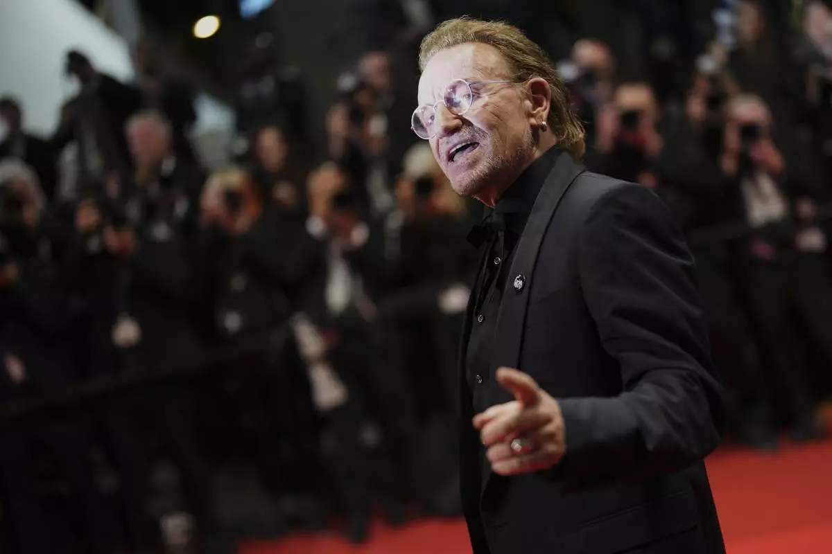 Bono poses for photographers upon arrival at the premiere of the film 'Bono: Stories of Surrender' at the 78th international film festival, Cannes, southern France, Friday, May 16, 2025. (Photo by Lewis Joly/Invision/AP)