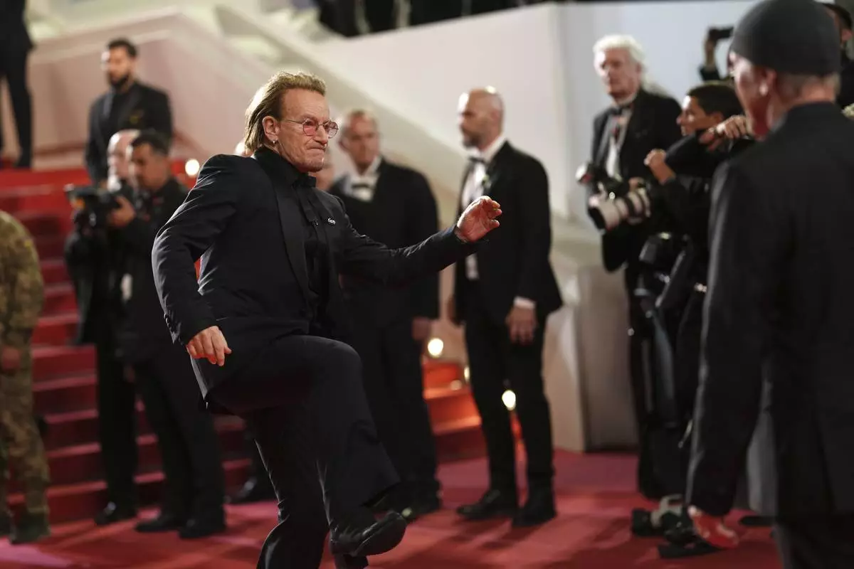 Bono poses for photographers upon arrival at the premiere of the film 'Bono: Stories of Surrender' at the 78th international film festival, Cannes, southern France, Friday, May 16, 2025. (Photo by Lewis Joly/Invision/AP)