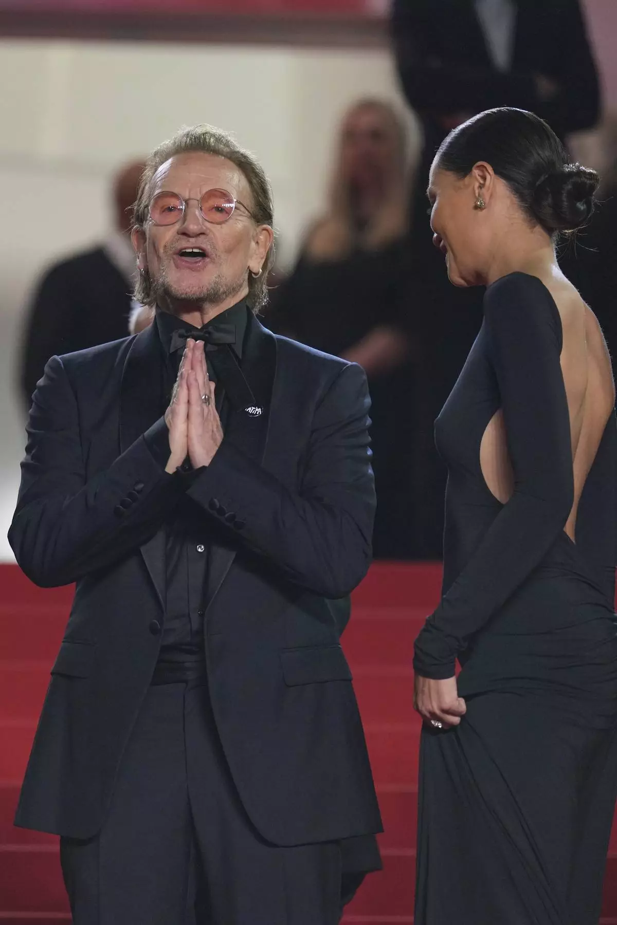 Bono, left, poses for photographers upon arrival at the premiere of the film 'Bono: Stories of Surrender' at the 78th international film festival, Cannes, southern France, Friday, May 16, 2025. (AP Photo/Natacha Pisarenko)
