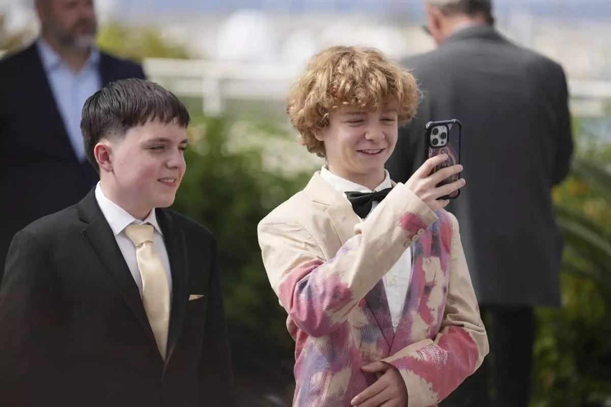 Kenny Rasmussen, left, and Kayo Martin pose for photographers at the photo call for the film 'The Plague' at the 78th international film festival, Cannes, southern France, Friday, May 16, 2025. (AP Photo/Natacha Pisarenko)
